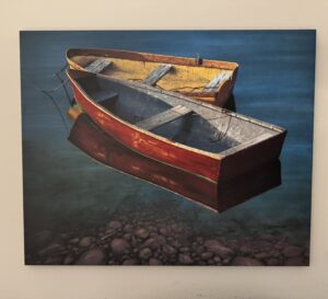 Two colorful rowboats anchored on a lake